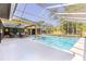 Beautiful screened-in pool area with an outdoor seating area and lush backyard at 400 Royal Palm Ct, Longwood, FL 32779