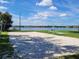 A community volleyball court and a view of a tranquil lake at 400 Royal Palm Ct, Longwood, FL 32779