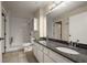 Bathroom featuring double sinks, granite countertops, and accessible shower at 404 Summit Ridge Pl # 110, Longwood, FL 32779
