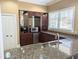 Modern kitchenette with granite counters, stainless steel appliances, and stylish cabinetry at 404 Summit Ridge Pl # 110, Longwood, FL 32779