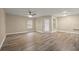 Spacious living room featuring wood floors, ceiling fan, and natural light from multiple windows at 404 Summit Ridge Pl # 110, Longwood, FL 32779