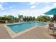 Resort-style swimming pool with lounge chairs, umbrellas, and serene water features at 404 Summit Ridge Pl # 110, Longwood, FL 32779