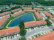 Beautiful aerial view of the community featuring a scenic pond surrounded by townhomes at 4720 Hemingway House St, Kissimmee, FL 34746