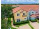 An aerial view of the townhome showcasing the red tile roof, landscaping, and overall community at 4720 Hemingway House St, Kissimmee, FL 34746