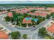 Stunning aerial view of a residential community, showcasing a large pool, tennis courts, and well-maintained landscaping at 4720 Hemingway House St, Kissimmee, FL 34746