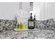 Close up of bathroom granite countertop featuring travel sized toiletries and soaps for guests at 4720 Hemingway House St, Kissimmee, FL 34746