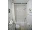 Clean bathroom featuring a granite countertop, shower/tub combo with a white shower curtain, and toilet at 4720 Hemingway House St, Kissimmee, FL 34746