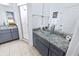 Elegant bathroom with glass bowl sinks, granite countertops, modern gray cabinets, and a glass door shower at 4720 Hemingway House St, Kissimmee, FL 34746