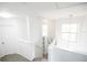 Bright and open second floor landing features natural light, neutral tones, and access to multiple rooms at 4720 Hemingway House St, Kissimmee, FL 34746