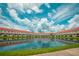 Scenic view of townhomes reflected in the pond creating a tranquil and serene atmosphere at 4720 Hemingway House St, Kissimmee, FL 34746