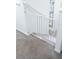 White baby gate installed at the top of the stairs for safety in a light and airy home at 4720 Hemingway House St, Kissimmee, FL 34746