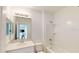 Cozy bathroom featuring a shower-tub combo and a sleek vanity with a large mirror at 4747 Cloister St, Kissimmee, FL 34758