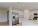 Spacious kitchen with stainless steel appliances, white cabinetry, and ample counter space at 4747 Cloister St, Kissimmee, FL 34758