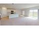 Open-concept living room with kitchen, sliding glass doors leading to the backyard at 4747 Cloister St, Kissimmee, FL 34758