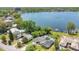 Expansive aerial view showcasing a beautiful lake, a home with a private pool, and lush landscaping with the city skyline at 673 Balmoral Rd, Winter Park, FL 32789