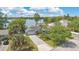Aerial view of a beautifully landscaped home with a paver driveway and access to the lake at 673 Balmoral Rd, Winter Park, FL 32789