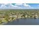 Vast aerial view of lakefront houses featuring private docks and lush surroundings in a tranquil neighborhood setting at 673 Balmoral Rd, Winter Park, FL 32789