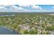 Expansive aerial shot displaying a dense neighborhood and lakefront properties with private docks and lush greenery at 673 Balmoral Rd, Winter Park, FL 32789