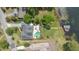 Overhead shot of home with a private pool, patio, and well-manicured lawn leading to a boat dock on the lake at 673 Balmoral Rd, Winter Park, FL 32789