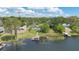 Aerial shot of lakeside property with boat dock, lush landscaping, private pool, and neighboring houses at 673 Balmoral Rd, Winter Park, FL 32789