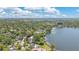 Gorgeous aerial perspective of a lakeside neighborhood featuring lush greenery and waterfront homes with private docks at 673 Balmoral Rd, Winter Park, FL 32789