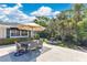 Backyard patio showing outdoor dining space with comfortable seating and meticulously landscaped garden at 673 Balmoral Rd, Winter Park, FL 32789