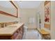 A bathroom with double sinks, tile floors, and a framed mirror at 673 Balmoral Rd, Winter Park, FL 32789