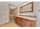 Elegant bathroom showcasing a rustic wood vanity, double sinks, tiled shower, and stylish fixtures at 673 Balmoral Rd, Winter Park, FL 32789