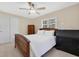 Bedroom with white bedding, ceiling fan, and natural lighting at 673 Balmoral Rd, Winter Park, FL 32789