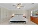 Inviting bedroom with a ceiling fan, wood furniture, and a serene view from the window at 673 Balmoral Rd, Winter Park, FL 32789