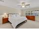 Bright bedroom featuring a comfortable bed, classic furniture, and view of lush outdoor scenery at 673 Balmoral Rd, Winter Park, FL 32789