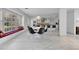 Open-concept dining area with a round table, modern lighting and a window seat overlooking the backyard at 673 Balmoral Rd, Winter Park, FL 32789