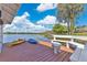Private dock on tranquil waters, equipped with colorful kayaks and comfortable bench seating at 673 Balmoral Rd, Winter Park, FL 32789