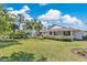 Charming single-story home featuring a well-manicured lawn, mature landscaping and a covered front porch at 673 Balmoral Rd, Winter Park, FL 32789