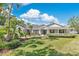 Charming single-story home featuring a well-manicured lawn, mature landscaping and a covered front porch at 673 Balmoral Rd, Winter Park, FL 32789