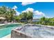 Close-up of the luxurious hot tub with views of the refreshing pool and serene waterfront at 673 Balmoral Rd, Winter Park, FL 32789