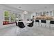 Eat-in kitchen with white cabinets, granite countertops, stainless steel appliances, and a window seat at 673 Balmoral Rd, Winter Park, FL 32789