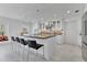 Spacious kitchen featuring white cabinets, black countertops, stainless steel appliances, and a breakfast bar at 673 Balmoral Rd, Winter Park, FL 32789