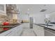 Bright kitchen with white cabinets, granite countertops, stainless steel appliances, and tile flooring at 673 Balmoral Rd, Winter Park, FL 32789