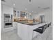 Stylish kitchen with island, granite countertops, white cabinets, and stainless steel appliances at 673 Balmoral Rd, Winter Park, FL 32789