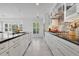 Modern kitchen featuring stainless steel appliances, granite countertops, white cabinets, and tiled floors at 673 Balmoral Rd, Winter Park, FL 32789