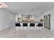 Open-concept kitchen with white cabinetry, stainless steel appliances, and a large center island with bar seating at 673 Balmoral Rd, Winter Park, FL 32789