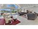 Well-lit living room boasts tiled floors, large windows with water views, and comfortable seating at 673 Balmoral Rd, Winter Park, FL 32789