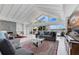 Open-concept living room with tiled floors, fireplace, water views, and ample seating at 673 Balmoral Rd, Winter Park, FL 32789