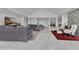 Spacious living room with tiled floor, fireplace, gray sofa, and views of the pool and waterway at 673 Balmoral Rd, Winter Park, FL 32789