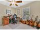 Bright office space with guitars, wood desk and natural light at 673 Balmoral Rd, Winter Park, FL 32789