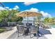 Stylish outdoor dining area with an umbrella, perfect for enjoying meals with scenic waterfront views at 673 Balmoral Rd, Winter Park, FL 32789