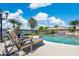Beautiful backyard pool area with comfortable lounge chairs and picturesque lake views, perfect for relaxing at 673 Balmoral Rd, Winter Park, FL 32789