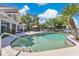 A spacious pool and landscaped yard with palm trees at 673 Balmoral Rd, Winter Park, FL 32789