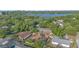 Stunning aerial view of a beautiful property with a screened-in pool and solar panels at 690 S Lakemont Ave, Winter Park, FL 32792